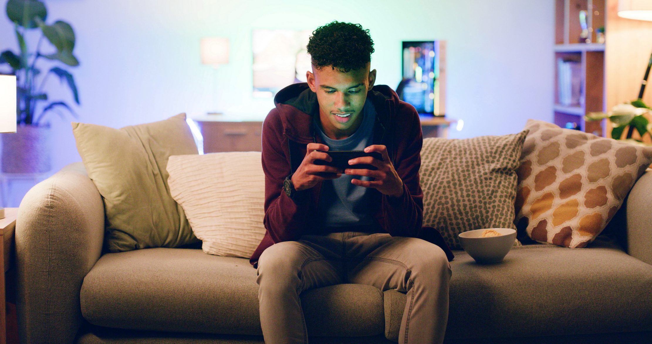 A young player using a mobile phone at home